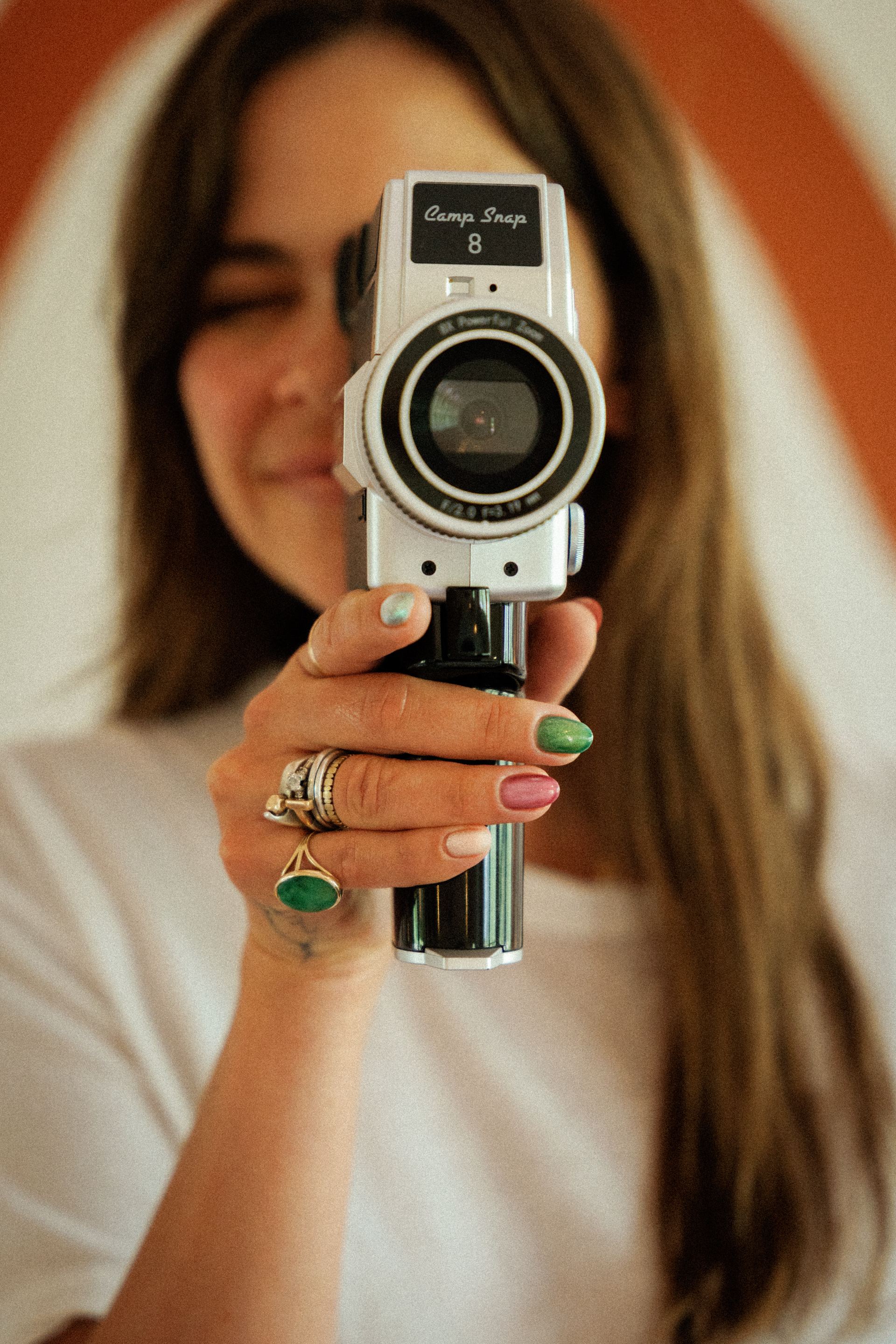 Hand with gel manicure holding a vintage Camp Snap movie camera