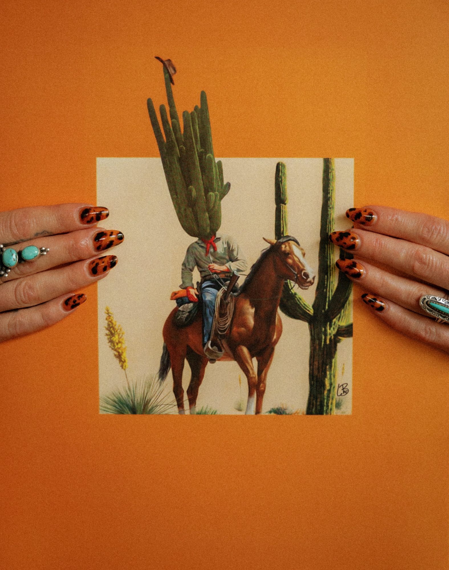Tortoiseshell nail art framing a vintage western print